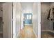 Hallway showcasing a closet and entryway to a room with blue walls and natural light at 7875 S Grand Baker St, Aurora, CO 80016