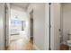 Hallway view leading to a bedroom with a ceiling fan and ample natural light at 7875 S Grand Baker St, Aurora, CO 80016