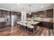 Well-equipped kitchen featuring a large island, stainless steel appliances, and dark wood cabinetry at 7875 S Grand Baker St, Aurora, CO 80016