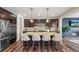 Spacious kitchen island with granite countertops, seating for four, and stylish pendant lighting at 7875 S Grand Baker St, Aurora, CO 80016