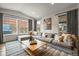 Spacious living room featuring large windows, a comfortable sectional sofa, and contemporary decor at 7875 S Grand Baker St, Aurora, CO 80016