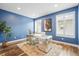 Home office with dark blue walls, hardwood floors, and a unique metal desk, ideal for a productive workspace at 7875 S Grand Baker St, Aurora, CO 80016