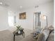 Cozy sitting room with carpet, a comfortable couch, and modern decor at 7875 S Grand Baker St, Aurora, CO 80016