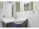 Simple bathroom with a white sink, dark brown vanity, and white wainscoting at 2795 S Lansing Way, Aurora, CO 80014