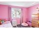 Bright bedroom featuring pink walls, a twin bed, and a double dresser at 2795 S Lansing Way, Aurora, CO 80014