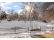 Winter view of community with pond and snow-covered landscaping at 2795 S Lansing Way, Aurora, CO 80014