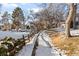 Snowy path with trees and community buildings visible at 2795 S Lansing Way, Aurora, CO 80014