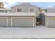 Townhouse exterior with snow-covered driveway and attached garage at 2795 S Lansing Way, Aurora, CO 80014