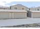 Gray townhome exterior with attached two-car garage and snowy front yard at 2795 S Lansing Way, Aurora, CO 80014