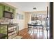 Kitchen with green cabinets, stainless steel appliances, and dining area at 2795 S Lansing Way, Aurora, CO 80014