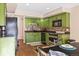 Galley style kitchen with green cabinets and stainless steel appliances at 2795 S Lansing Way, Aurora, CO 80014