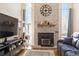 Living room featuring a brick fireplace and large windows at 2795 S Lansing Way, Aurora, CO 80014