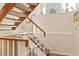 Indoor staircase with wooden handrail and carpeted steps at 2795 S Lansing Way, Aurora, CO 80014