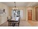 Bright dining room with a wooden door, a table setting, chandelier, and large window at 1146 W 144Th Pl, Westminster, CO 80023