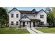 Charming modern farmhouse with brick accents, a welcoming front porch, and well-manicured landscaping at 15268 Detroit St, Thornton, CO 80602