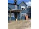 New construction home featuring blue siding, white windows, and a covered porch area at 15268 Detroit St, Thornton, CO 80602