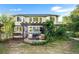 Large backyard with deck, pergola, mature trees, and lush greenery offering tranquil outdoor space at 634 E 130Th Way, Thornton, CO 80241
