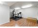 Basement exercise room with wood-look flooring, bright lighting, and treadmill and weight training equipment at 634 E 130Th Way, Thornton, CO 80241