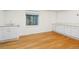 Bright basement room with wood floors, utility sink, small window, and white cabinets with light counter at 634 E 130Th Way, Thornton, CO 80241