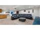 Finished basement featuring a sectional sofa, mini bar, and entertainment area at 634 E 130Th Way, Thornton, CO 80241
