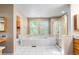 Bathroom featuring a large soaking tub, tile floor, vanity and a glass-enclosed shower at 634 E 130Th Way, Thornton, CO 80241