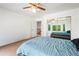 Bedroom with carpeted floors, ceiling fan, door to hallway and mirrored closet doors reflecting another room at 634 E 130Th Way, Thornton, CO 80241
