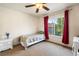 Bedroom with window featuring drapes, ceiling fan, carpeted floors and a white bedside table at 634 E 130Th Way, Thornton, CO 80241