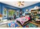 Bright bedroom with large windows, a ceiling fan, and a dedicated study area at 634 E 130Th Way, Thornton, CO 80241