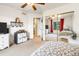 Bright bedroom featuring closet with mirrored doors, a ceiling fan, and natural light from a window at 634 E 130Th Way, Thornton, CO 80241