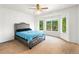 Carpeted bedroom featuring a bed with a studded headboard and large window with natural light at 634 E 130Th Way, Thornton, CO 80241