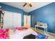 Blue bedroom with ample closet space and a cozy study area for  at 634 E 130Th Way, Thornton, CO 80241