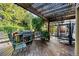 Back deck featuring grill, outdoor chairs, string lights, and foliage, perfect for outdoor living at 634 E 130Th Way, Thornton, CO 80241