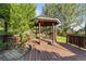 Backyard gazebo retreat with wood floor and seating, offering a tranquil escape in a lush setting at 634 E 130Th Way, Thornton, CO 80241