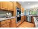 Modern kitchen showcases stainless steel appliances, granite counters, and light wood cabinetry at 634 E 130Th Way, Thornton, CO 80241