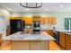 Gourmet kitchen features an island gas cooktop, stainless steel appliances, and granite countertops at 634 E 130Th Way, Thornton, CO 80241