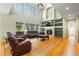 Bright living room boasts tall windows, a fireplace, and hardwood flooring at 634 E 130Th Way, Thornton, CO 80241