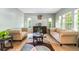 Cozy living room with two sofas, decorative rug and well-lit windows at 634 E 130Th Way, Thornton, CO 80241