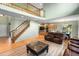 Open-concept living area featuring a staircase, wood floors, and access to the kitchen at 634 E 130Th Way, Thornton, CO 80241