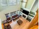 High-angle view of a living room with fireplace, furniture, and a staircase at 634 E 130Th Way, Thornton, CO 80241