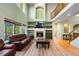 Bright living room with a fireplace, built-in shelves, and large windows at 634 E 130Th Way, Thornton, CO 80241