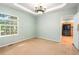 A well-lit room featuring plush carpeting and adjacent to a doorway with hardwood floors at 634 E 130Th Way, Thornton, CO 80241