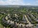 Aerial view of a residential neighborhood with mature trees and well-maintained homes at 10371 Knollside Dr, Parker, CO 80134