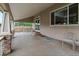 Covered back patio featuring brick pillars and textured concrete flooring at 10371 Knollside Dr, Parker, CO 80134