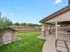 Landscaped backyard with covered patio, privacy fence, and small shed at 10371 Knollside Dr, Parker, CO 80134