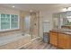 Bright bathroom featuring a garden tub, glass enclosed shower, and wood-look tile flooring at 10371 Knollside Dr, Parker, CO 80134