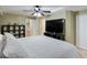 A well-lit bedroom with a plush bed, entertainment center, and easy access to other rooms at 10371 Knollside Dr, Parker, CO 80134