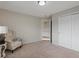 Cozy bedroom featuring neutral walls, carpet flooring, closet, and chair with blanket at 10371 Knollside Dr, Parker, CO 80134