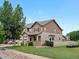 Lovely two-story house with inviting front porch, two car garage, and mature landscaping at 10371 Knollside Dr, Parker, CO 80134