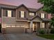 Beautiful two-story home with wood siding, stone accents, and a well-manicured lawn at 10371 Knollside Dr, Parker, CO 80134