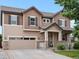 Charming two-story home with wood siding, stone accents, and a well-manicured lawn at 10371 Knollside Dr, Parker, CO 80134
